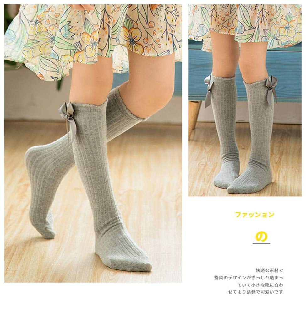 Five pairs of knee-high socks with a bow design for girls, sizes 3–12 toddlers, available in a variety of colors.